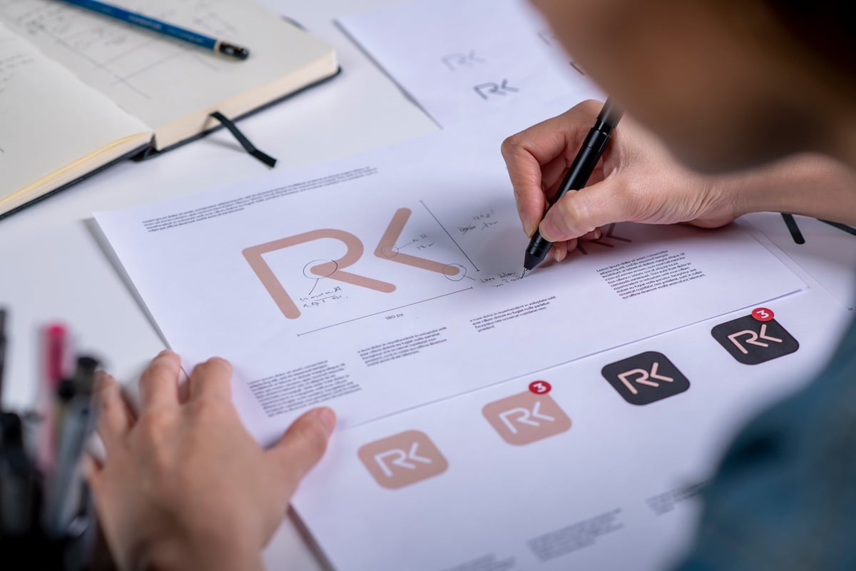 Graphic designer drawing sketches logo design